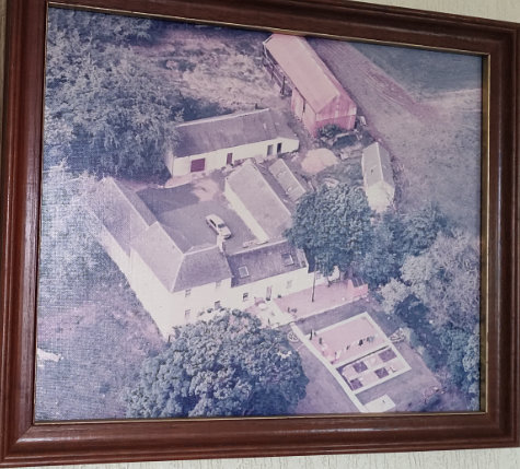 Aerial photo of an old farmhouse and outhouses